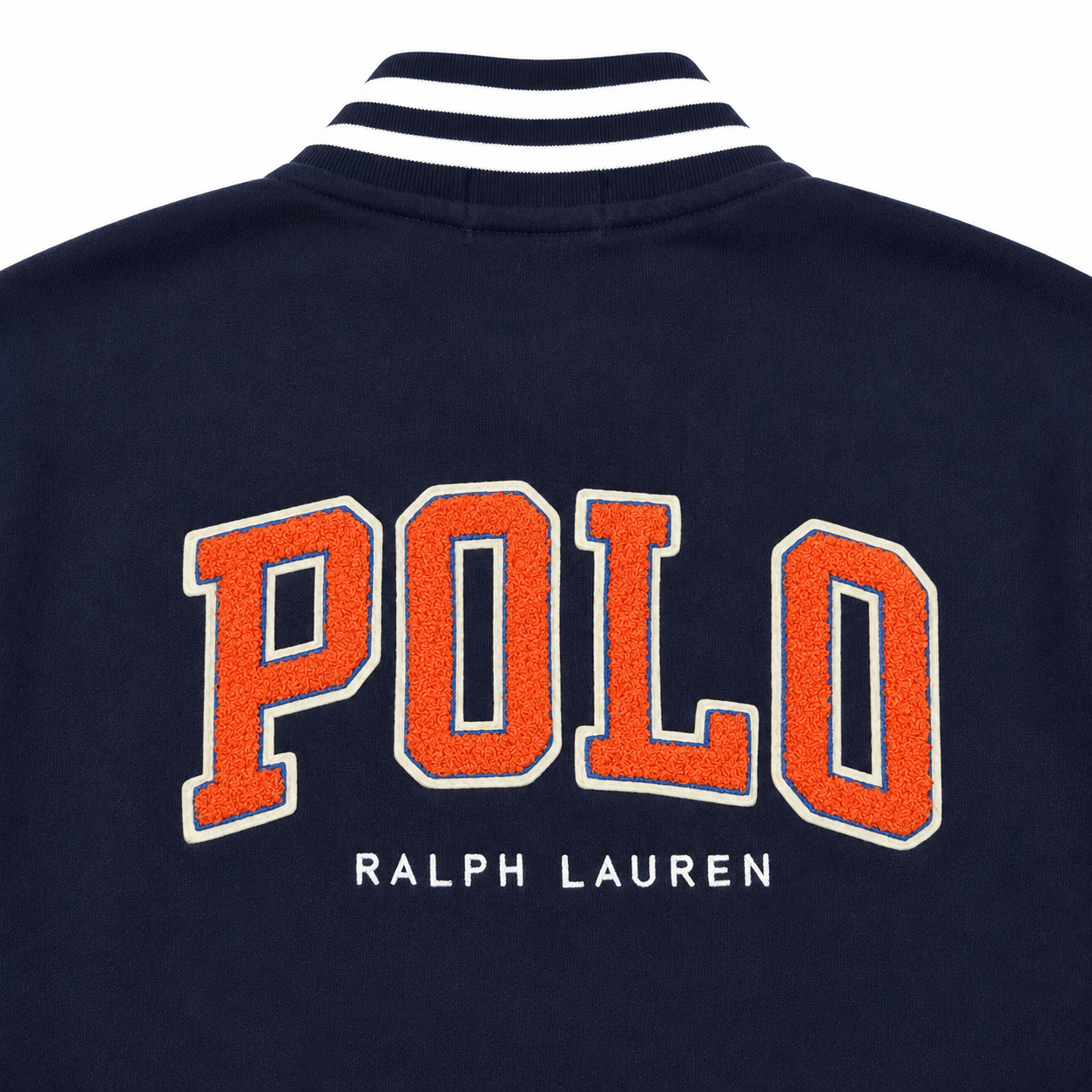 Close-up of the back of a navy blue Ralph Lauren Polo knit jacket, featuring large orange collegiate-style 'POLO' lettering with white outlines and 'RALPH LAUREN' printed below in white. The collar has navy and white stripes.