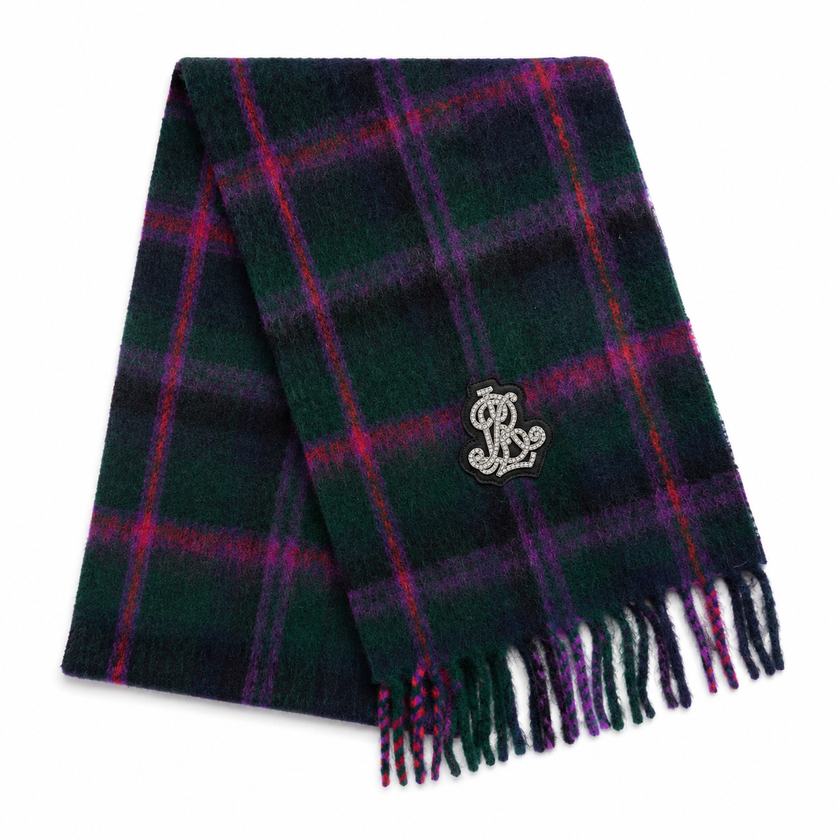 A dark green plaid scarf with purple and red stripes, featuring a silver embroidered monogram logo and fringed ends, displayed on a clean white background.