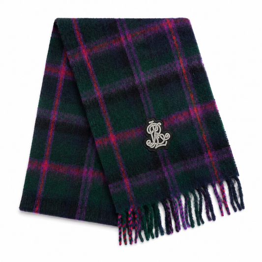 A dark green plaid scarf with purple and red stripes, featuring a silver embroidered monogram logo and fringed ends, displayed on a clean white background.