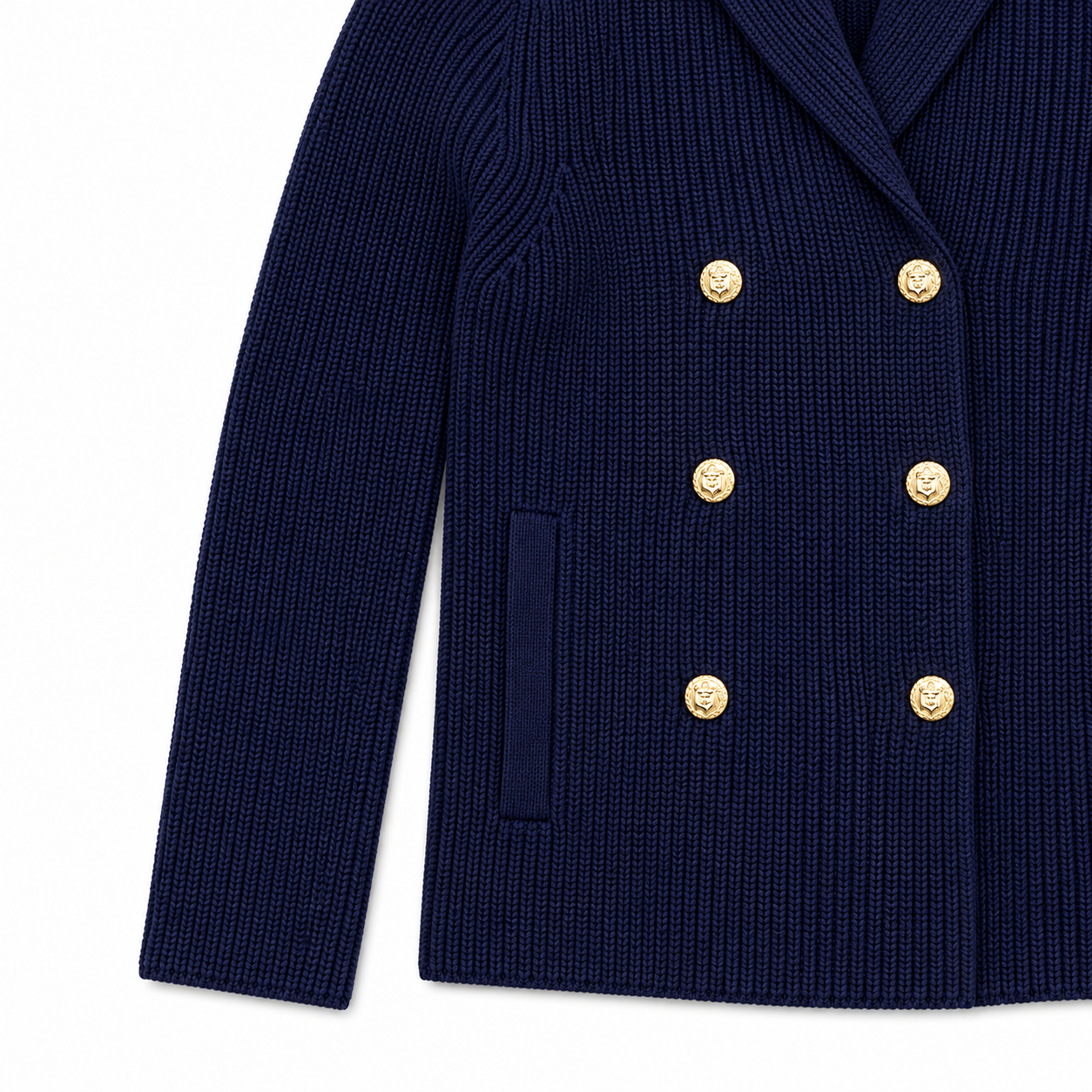 Close-up of a navy blue ribbed knit double-breasted cardigan with gold buttons, featuring a notch lapel and a side welt pocket, shown on a plain white background.