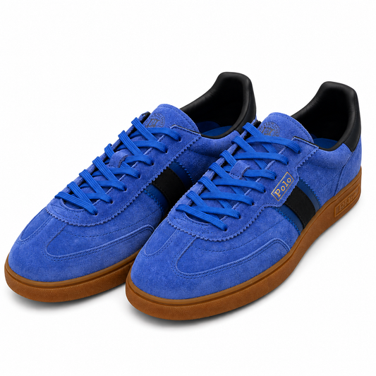 A pair of blue suede sneakers with black side stripes, blue laces, and brown gum soles, photographed on a clean white background.