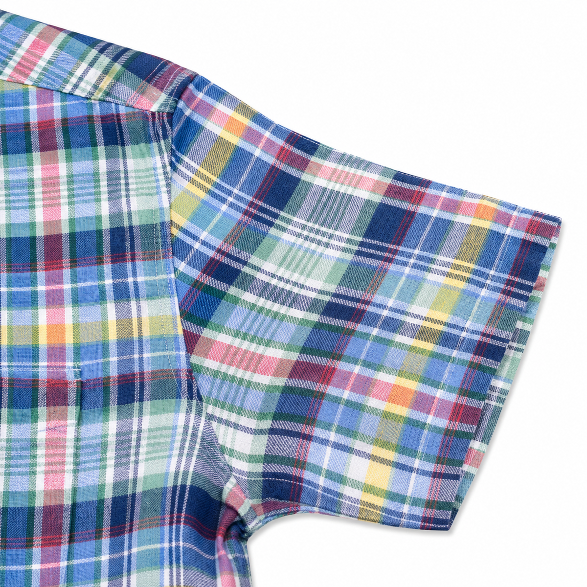 Close-up of a short-sleeve plaid shirt showing the sleeve and side panel with a multicolor tartan pattern in blue, green, pink, yellow, and white on a white background.