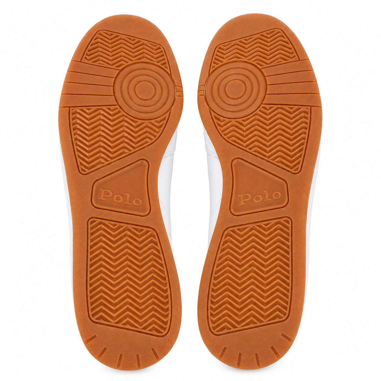 Top-down view of a pair of white sneakers showing their orange-brown rubber soles, with the brand name 'Polo' embossed on the heel sections.