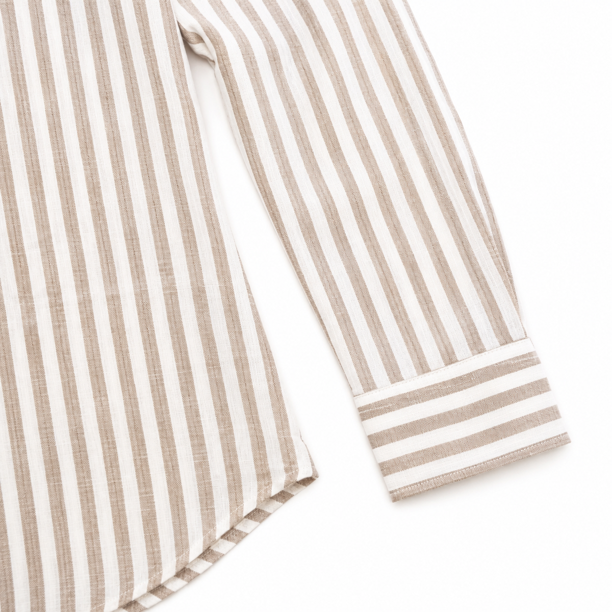 Close-up of a long-sleeve shirt or pajama with vertical beige and off-white stripes, showing the fabric texture and cuff detail on a white background.