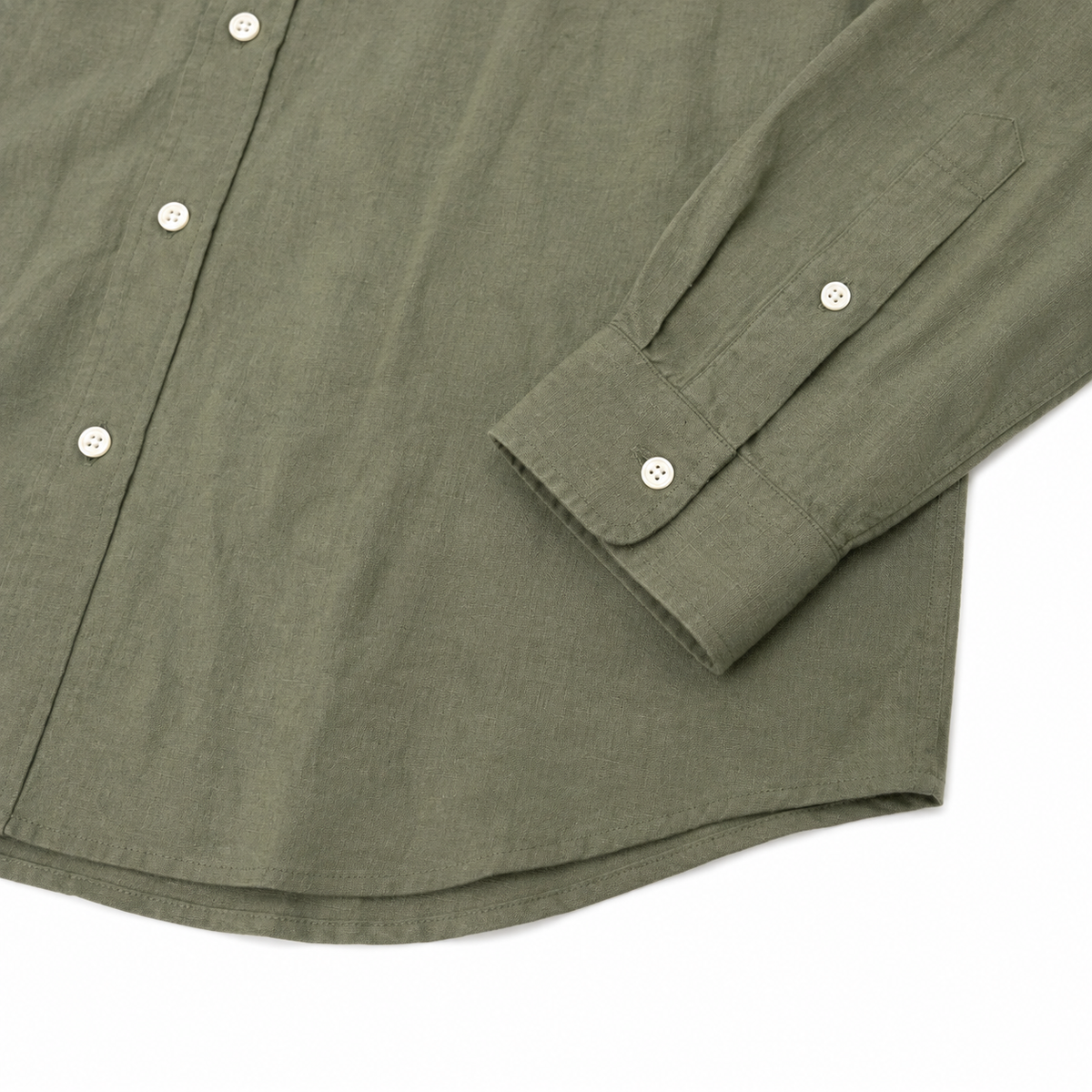 Close-up of an olive green long-sleeve button-up shirt with white buttons, showing the fabric texture and cuff detail against a white background.