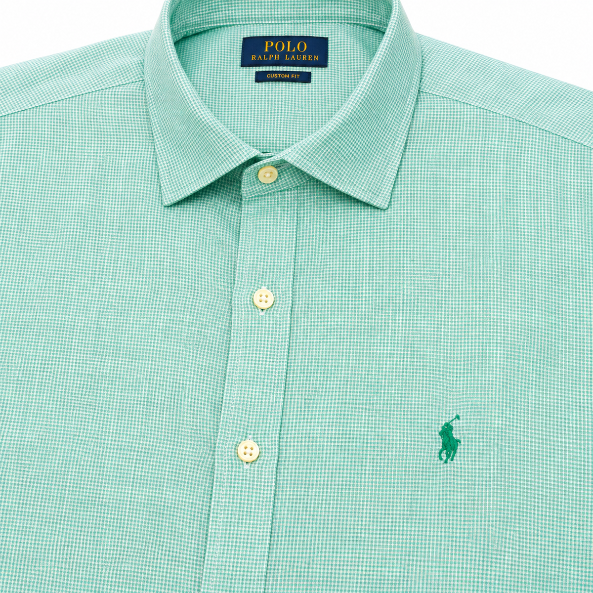 A close-up of a Polo Ralph Lauren men's dress shirt in a light mint green and white micro-check pattern, featuring a classic collar, button-down front, and the signature green polo player logo on the chest.