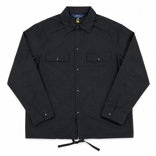 A black long-sleeve utility shirt jacket by Polo Ralph Lauren, featuring a button-down front, two chest flap pockets, and a drawstring hem, laid flat on a white background.
