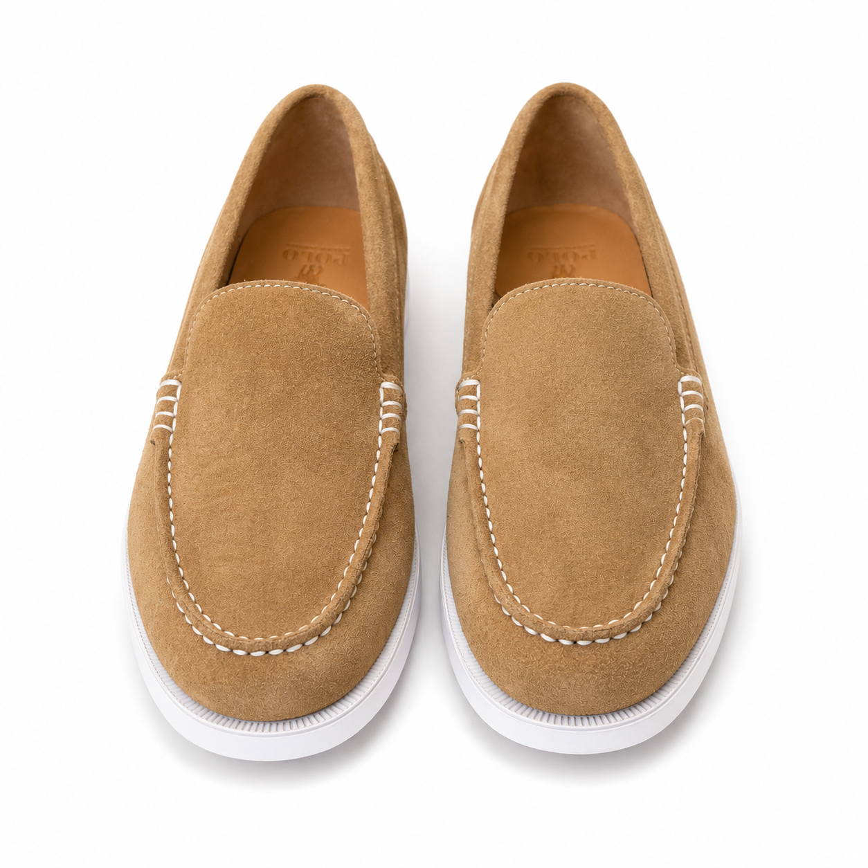 A pair of tan suede slip-on loafers with white stitching and white soles, shown from a top-down view on a white background.