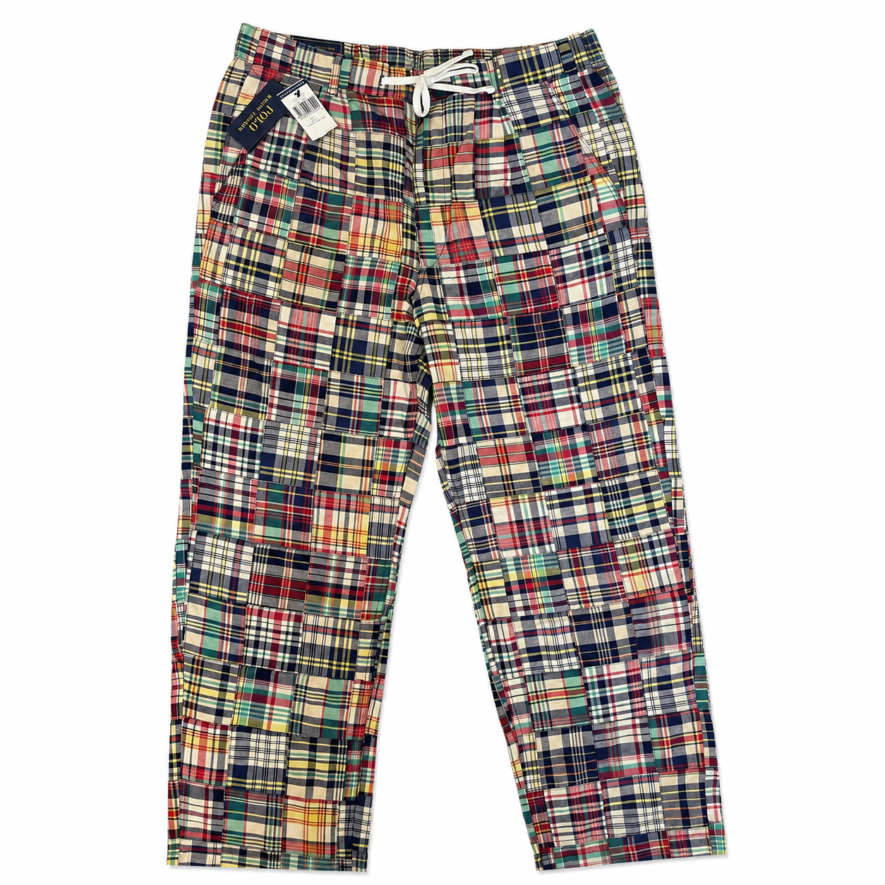 A pair of patchwork plaid pajama pants with a white drawstring waist, displayed flat against a white background. The pants feature a multicolor patchwork design of various plaid patterns in red, green, blue, yellow, and black.