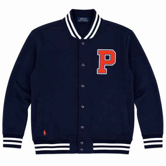 A navy blue Polo Ralph Lauren varsity jacket with white and navy striped ribbed collar, cuffs, and hem, featuring a red and white embroidered letter 'P' on the chest and a small red polo player on the lower left front.