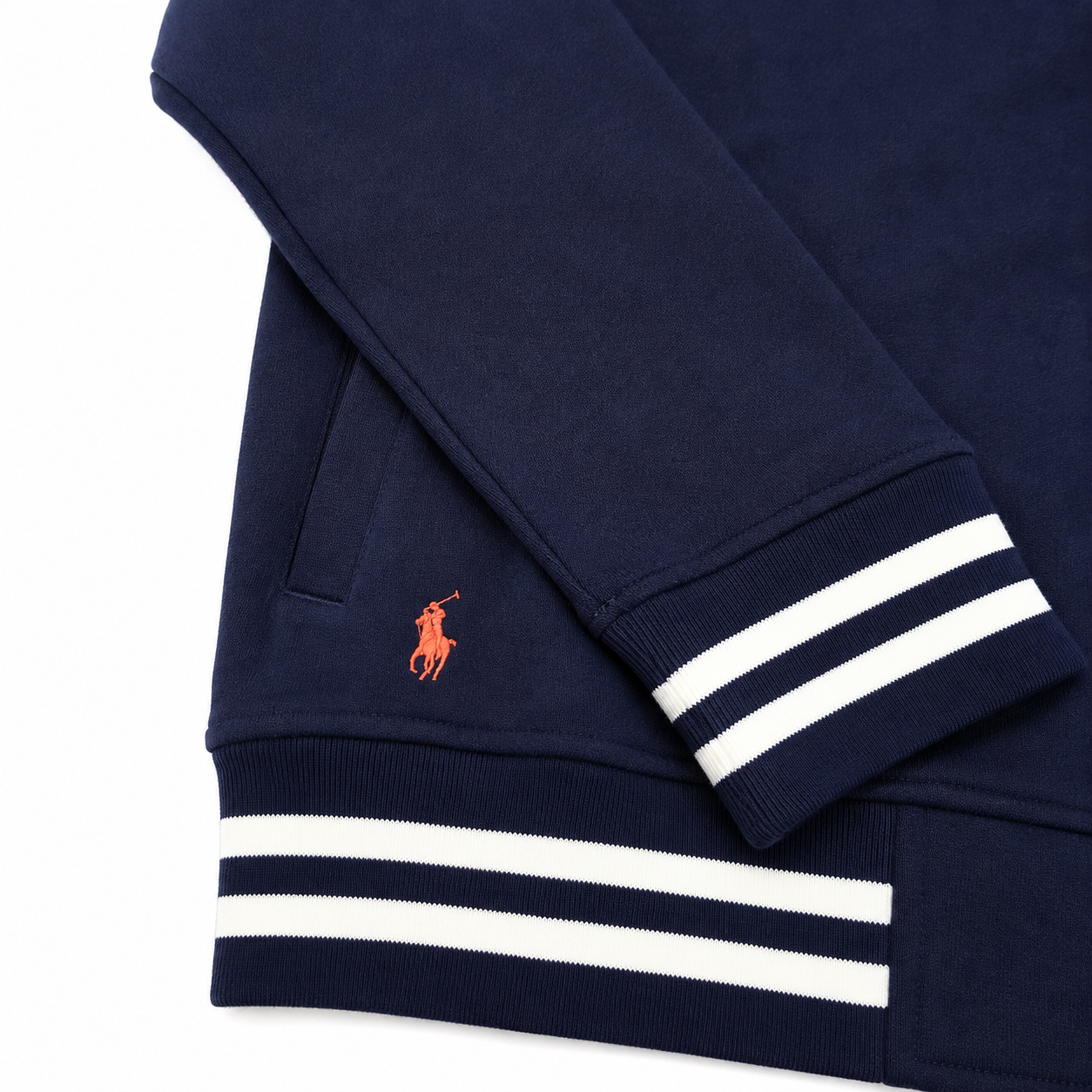 Close-up of a navy blue sweatshirt with white double stripes on the cuffs and hem, featuring the signature orange embroidered polo player logo on the chest.