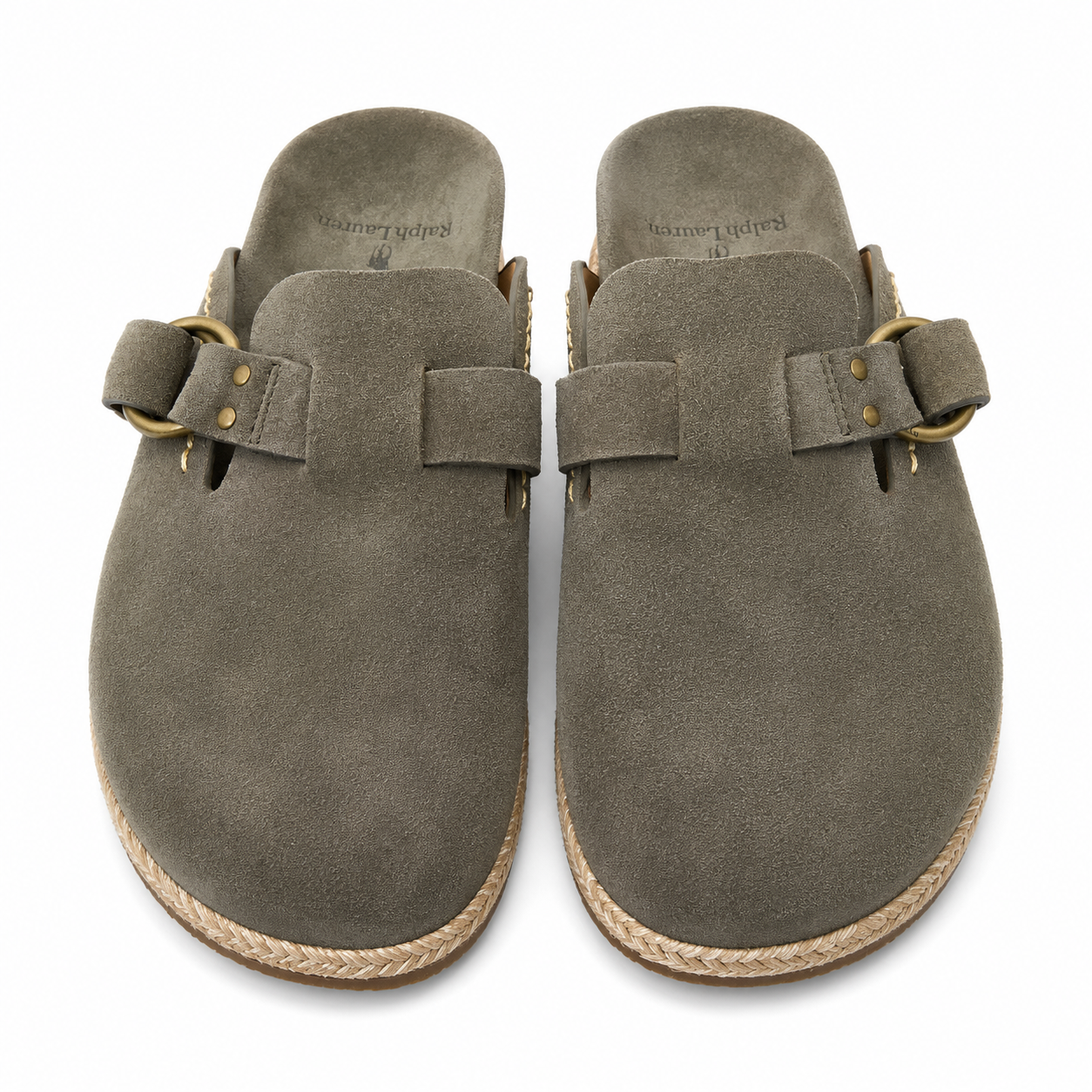 A pair of taupe suede clogs with braided jute soles and brass buckle straps, shown from a top-down view on a white background.