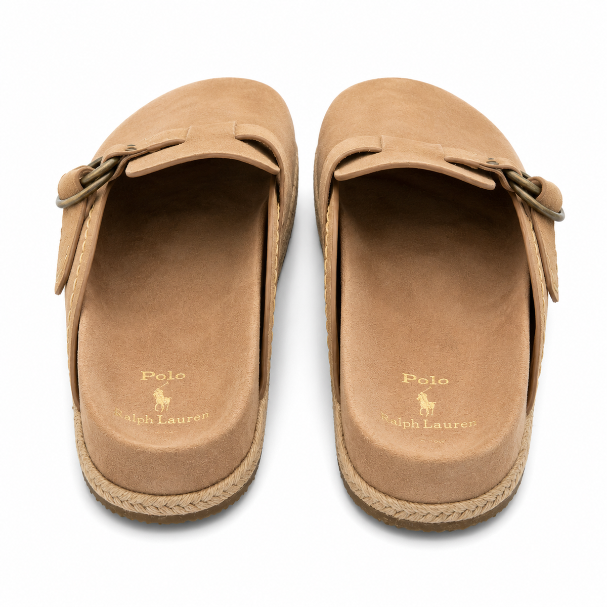 A pair of tan suede clogs by Polo Ralph Lauren, shown from a top-down view on a white background. Each clog features a decorative strap with a metal ring detail on the vamp and a braided jute-wrapped sole.