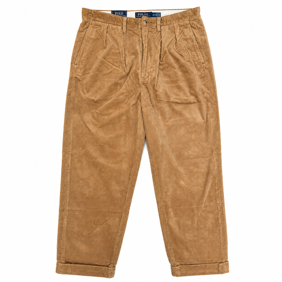 A pair of tan corduroy trousers with a relaxed straight-leg fit, laid flat against a white background. The brand name 'JIL SANDER' is visible on the inner waistband labels.