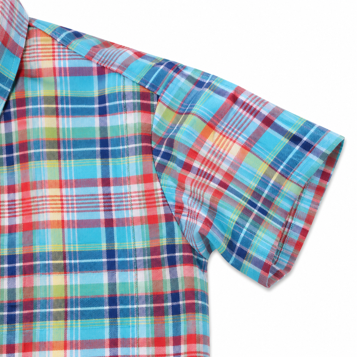A close-up of a short-sleeve plaid shirt showing the collar and right sleeve. The fabric features a multicolor tartan pattern with prominent shades of light blue, red, navy, yellow, and white.